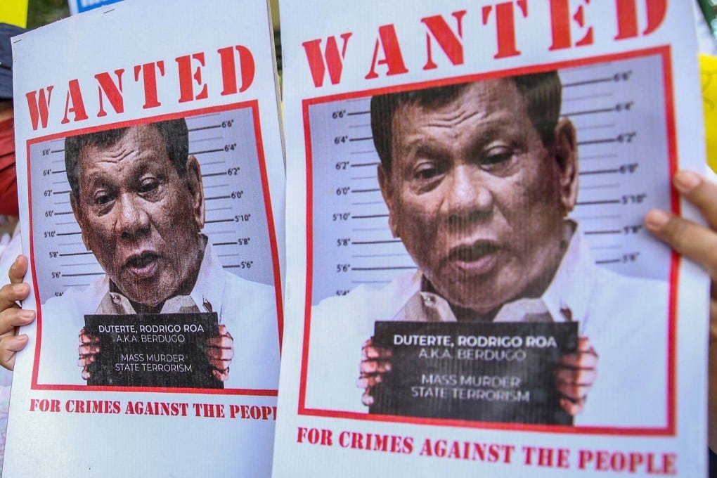 Supporters of Philippine lawmaker France Castro hold up wanted posters of former Philippine President Rodrigo Duterte. Photo: AFP