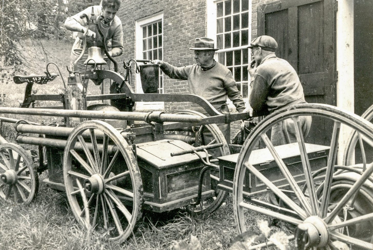 Three men with antique fire engine