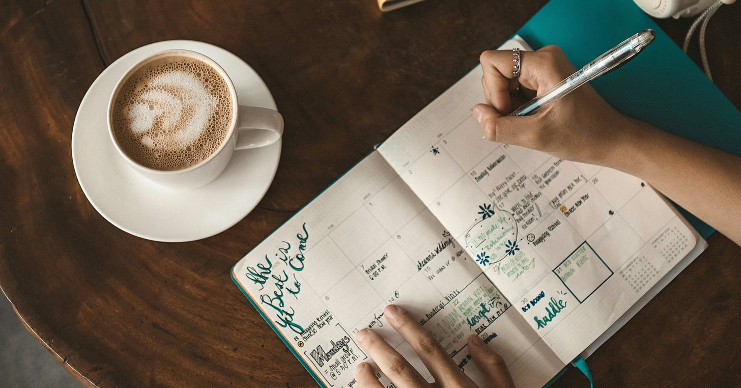 Woman scribbling notes while sitting at a coffee shop. Woman scribbling notes while sitting at a coffee shop.