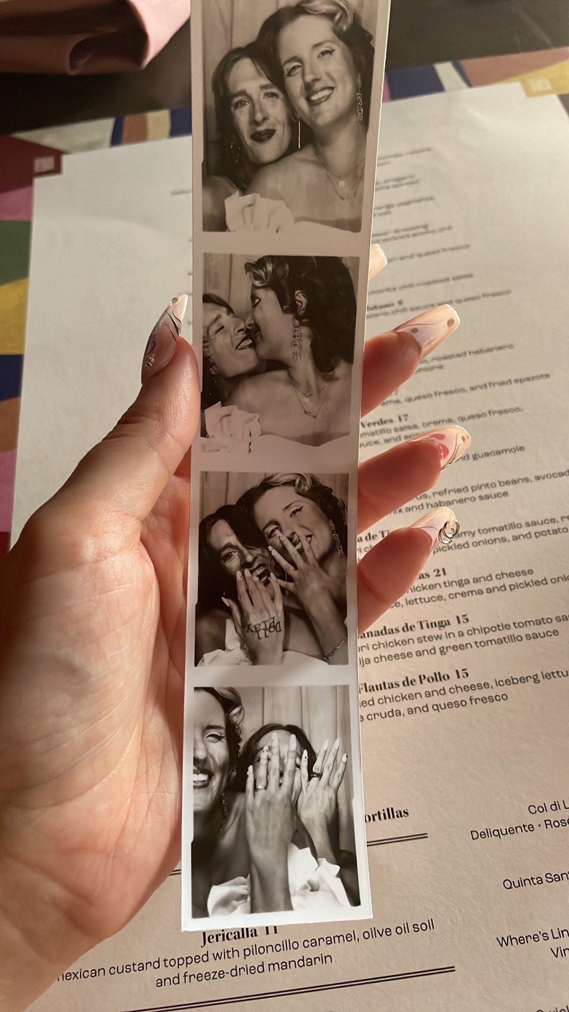 A black and white photostrip of me and Frankie, newly married and showing off our rings