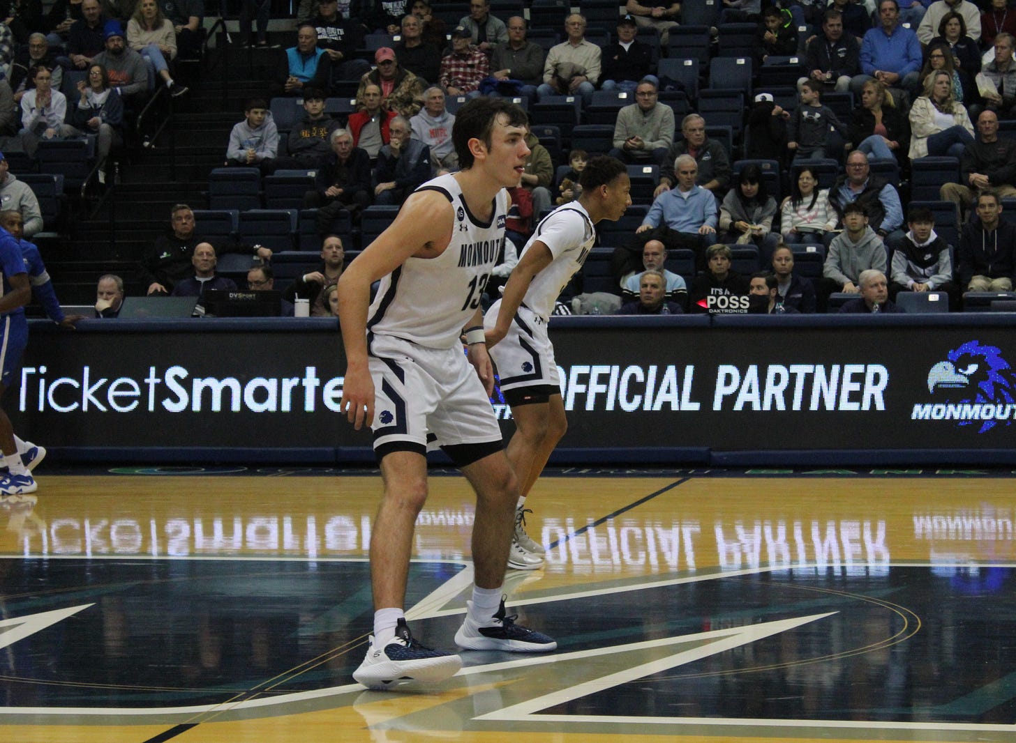 Jack Collins (13) prepares to play defense for Monmouth during a game on Feb. 11, 2023. (Photo by Adam Zielonka)