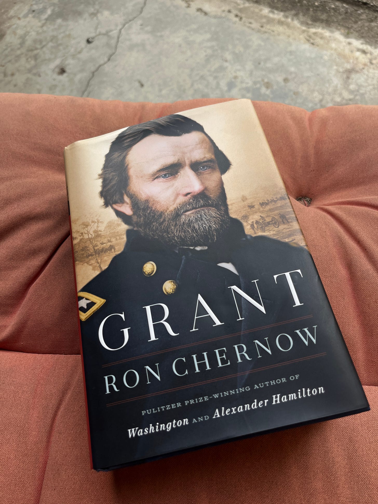 The cover of Ron Chernow's biography of Grant, a portrait of Grant in a Union uniform with glowing blue eyes, looking a little sad like he always did