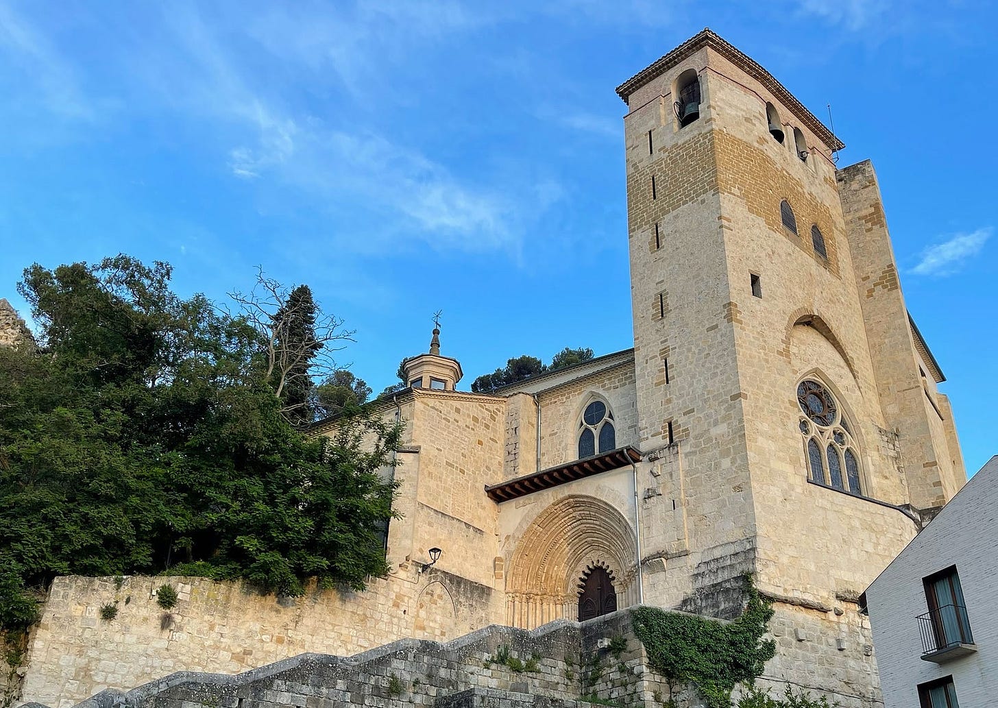 Looking up to an old church against a blue sky