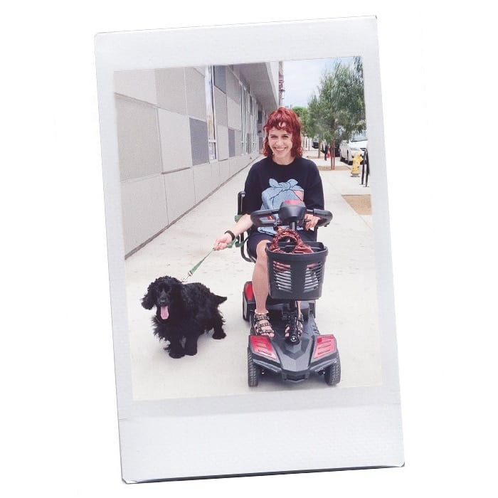 Paola with her dog Dedal in an electric scooter