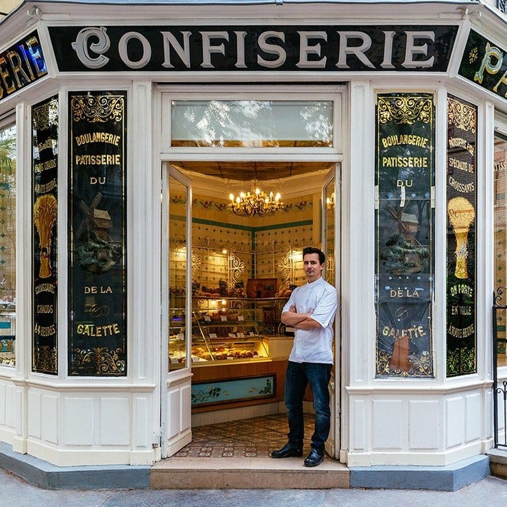 Boris Lumé, standing proudly at the entrance of his lovely bakery-confectionery.