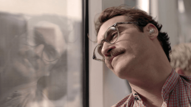 A scene from "Her" showing the protagonist wearing an earpiece to access AI