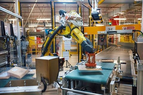 Robotic arm sorting packages at Amazon Innovation Lab