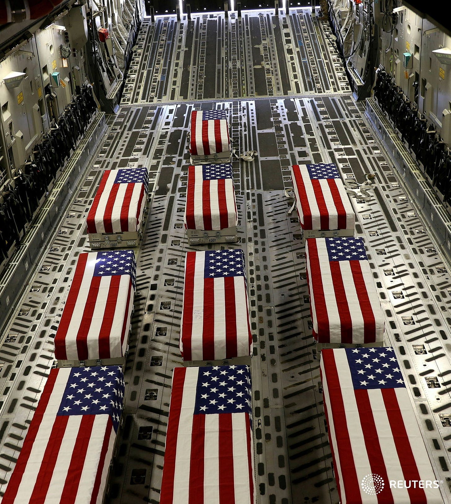 corinne_perkins on X: "Flag-draped coffins of service members killed in  action are loaded onto a transport aircraft during a ramp ceremony at Hamid  Karzai International Airport in Kabul, Afghanistan. Handout photo release