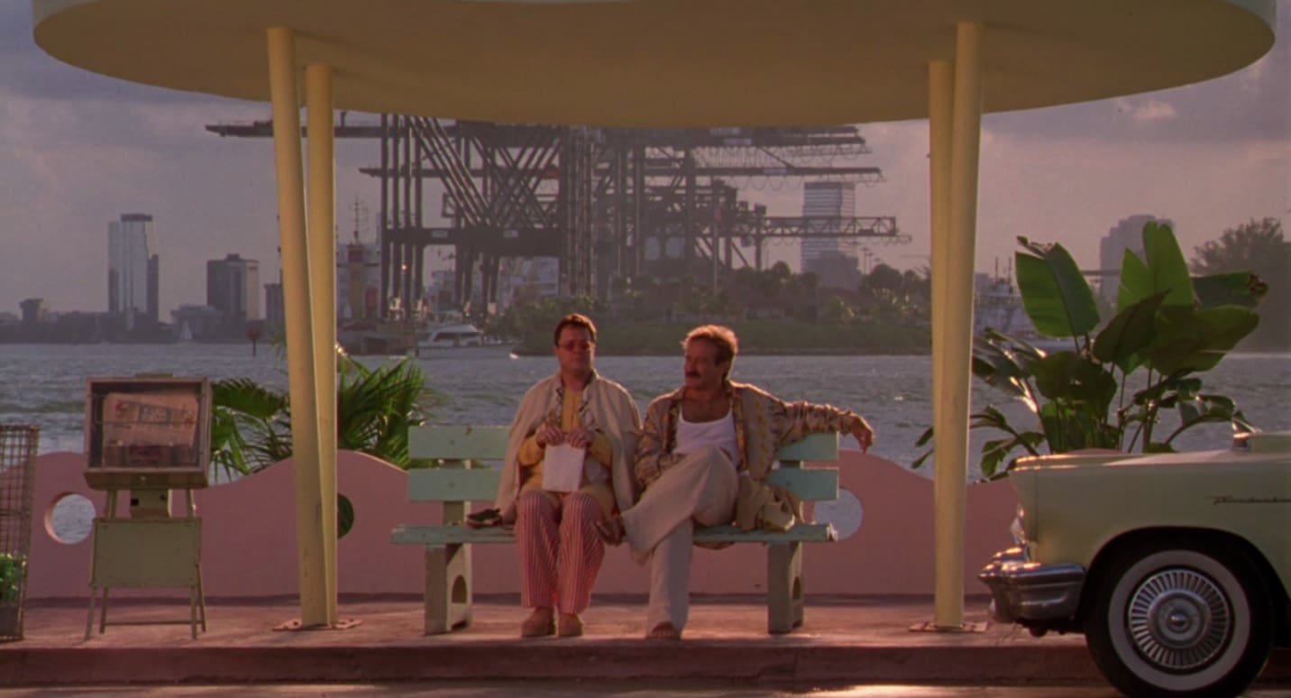 Nathan Lane and Robin Williams on a bench in The Birdcage.