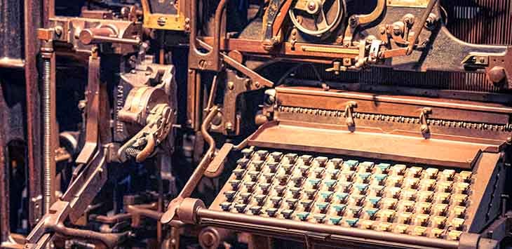 Photo of a huge metal machine with a keyboard in front of it.