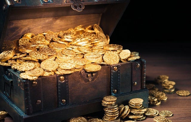 Treasure chest filled with gold coins | International Adviser