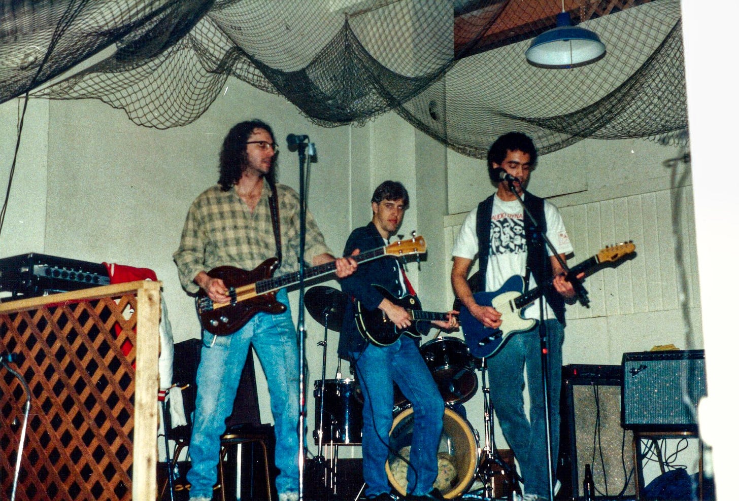 A rock band onstage in a small club