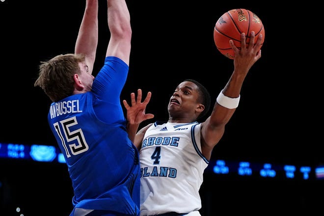 Rhode Island's Cam Estevez goes to the hoop against St. Louis' Stef van Bussel in Tuesday Atlantic 10 Tournament game at Barclays Center in New York.