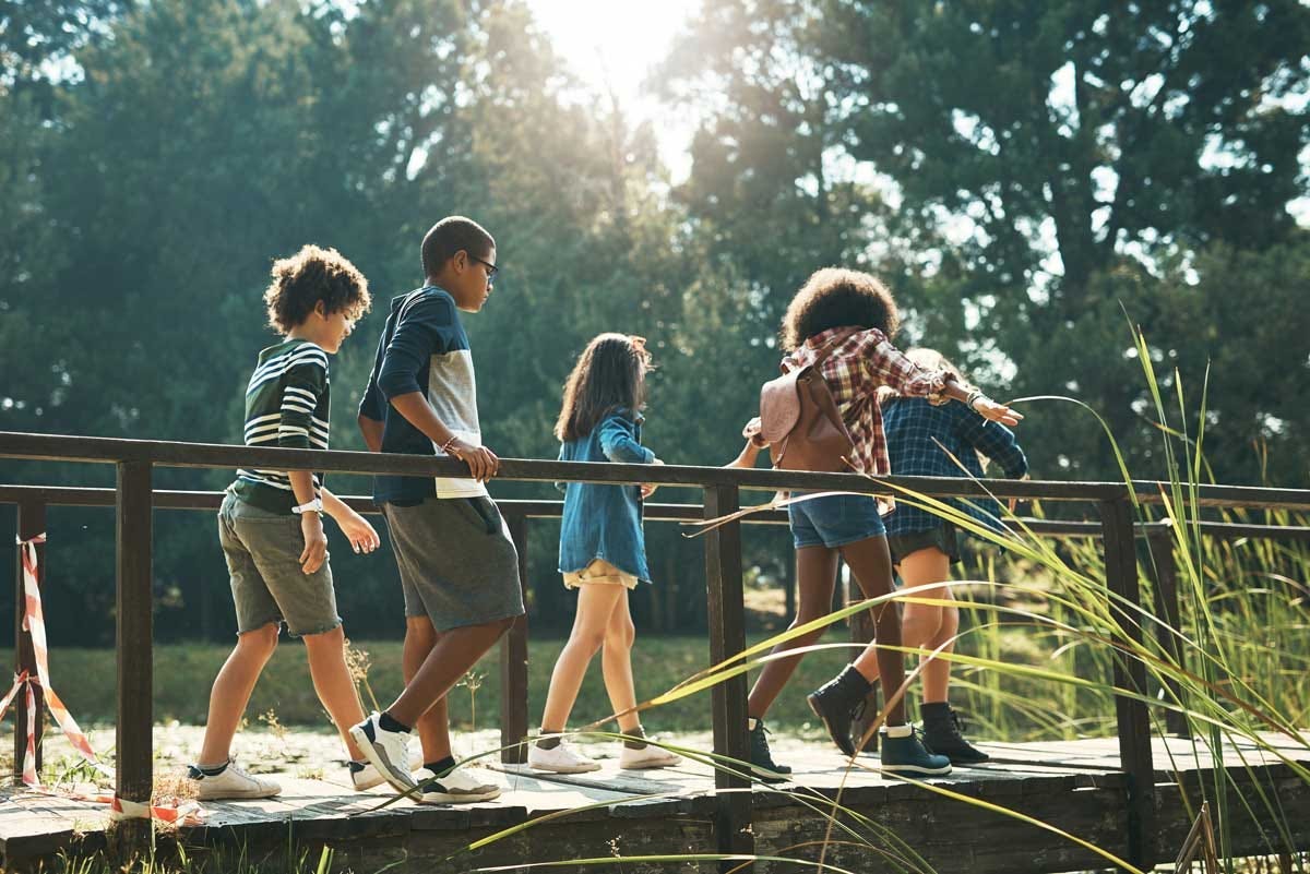 A group of young children exploring a park together.