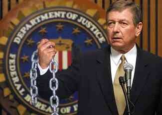 Ashcroft displays one of the chains that will bind him.
