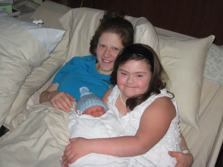A person holding a baby and smiling

AI-generated content may be incorrect.