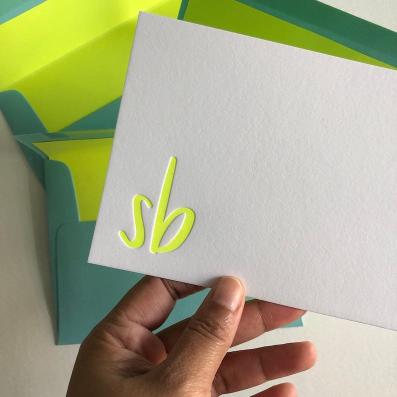 Letterpress stationery set with neon yellow ink and blue envelopes with neon yellow envelope liners