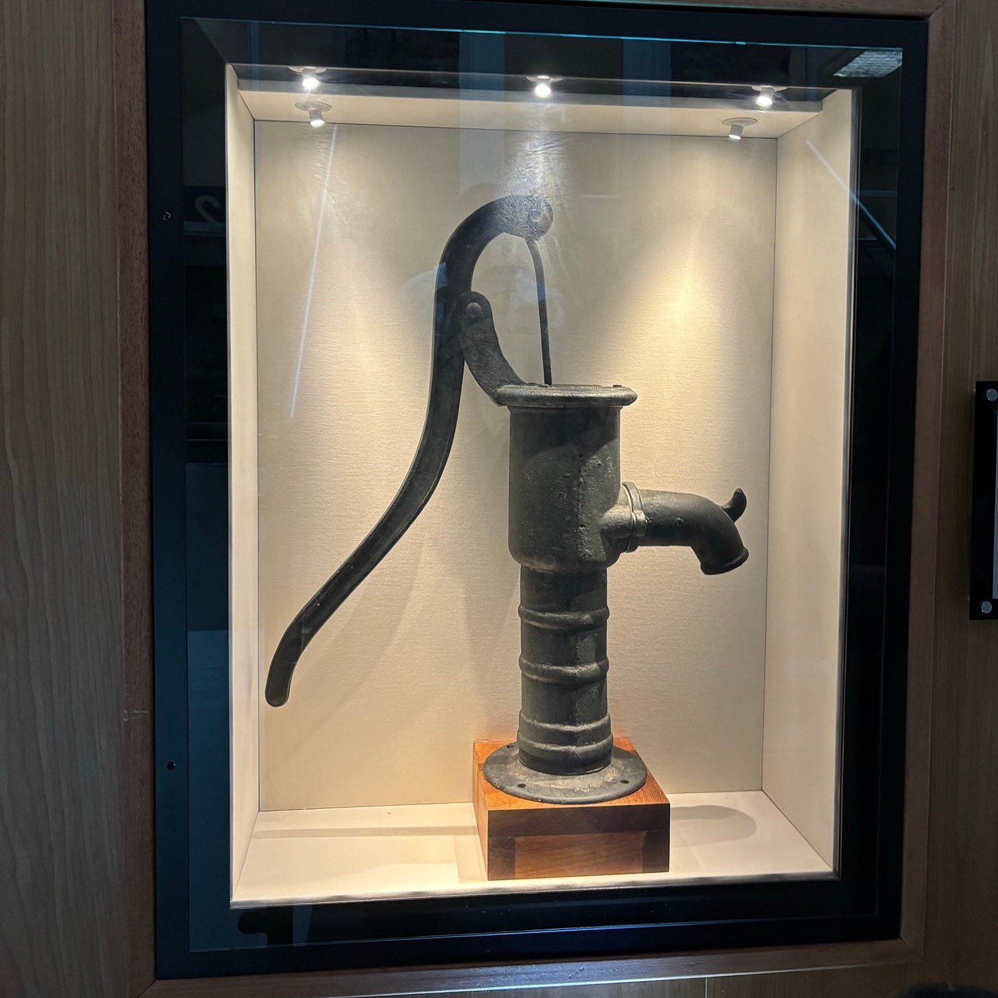 an old water pump in a display case