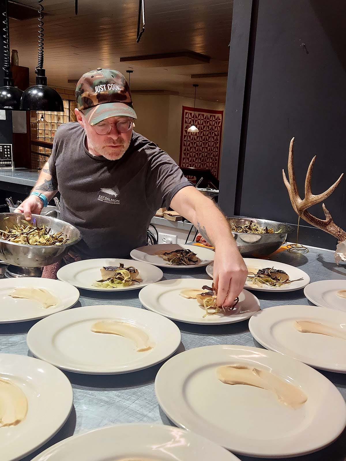 Hank plating a black cod dish. 