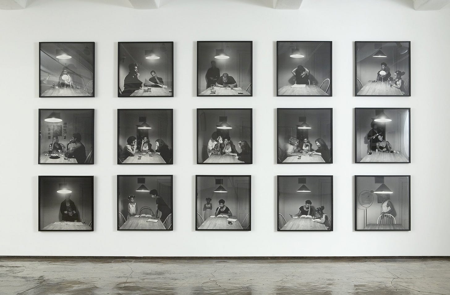 15 black and white photographs are lined up, 5 in each row of the Kitchen Table series. Each image shows different black people sitting or standing around the table, each doing various activities or poses. 15 black and white photographs are lined up, 5 in each row of the Kitchen Table series. Each image shows different black people sitting or standing around the table, each doing various activities or poses.