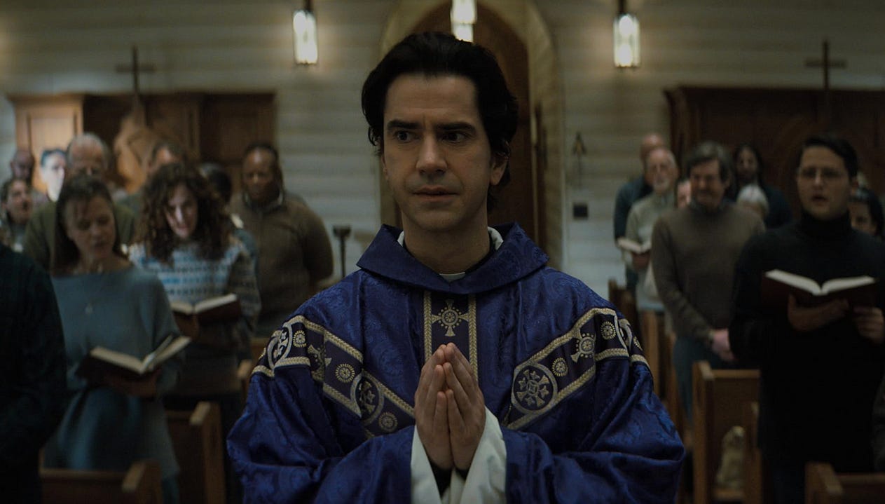 Image of pastor surrounded by congregation from the show Midnight Mass / Netflix