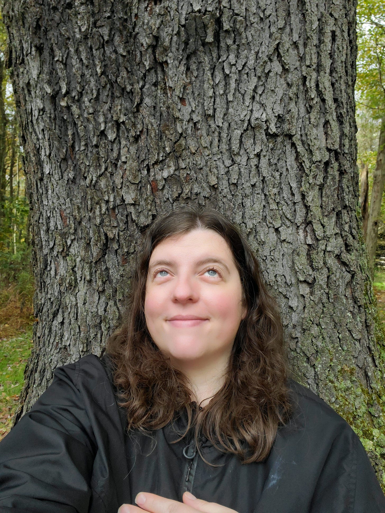 The author leading against a tree trunk.