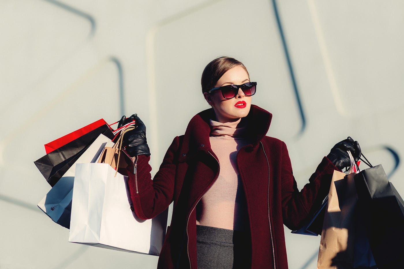 This is a photo of a fashionable lady carrying several shopping bags.