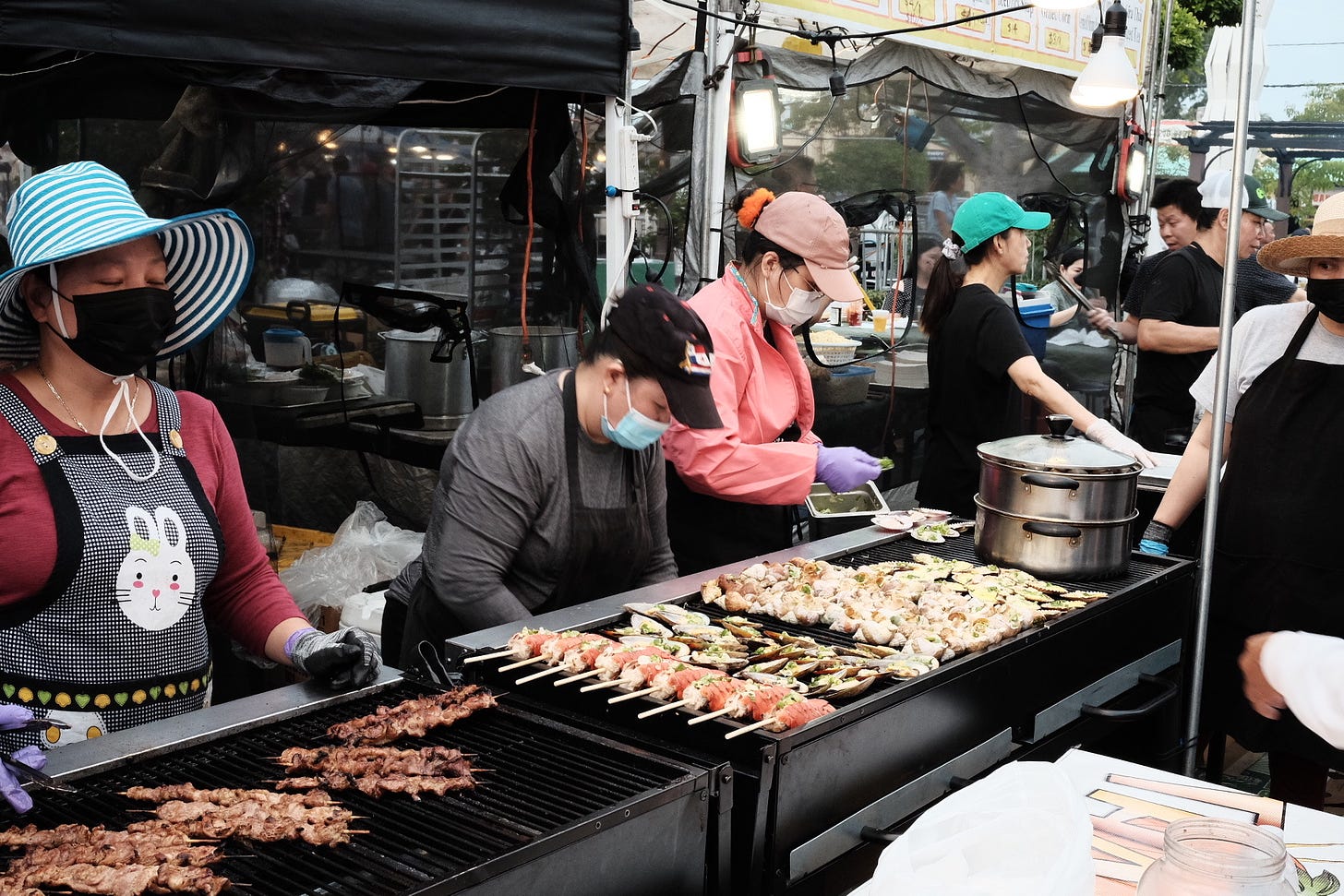 Women cooking at a grill during the Little Saigon Night Market