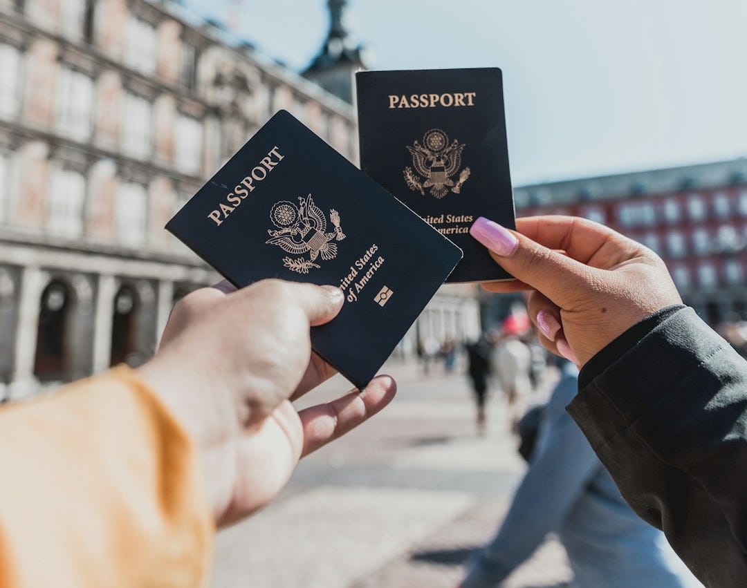 person holding passports person holding passports