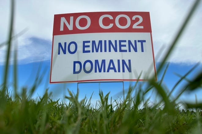 A sign reading "No CO2, no eminent domain" stands along a rural road east of Bismarck, North Dakota.