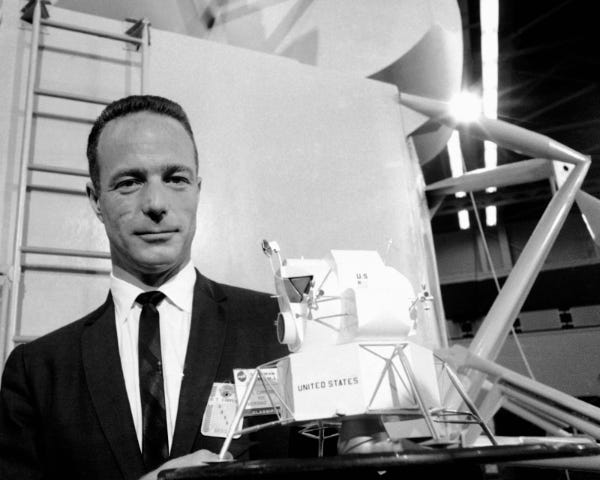 Astronaut Scott Carpenter poses with a model of the Lunar Excursion Module at the Grumman Aircraft Engineering Corp. plant in Bethpage, N.Y., March 1967. (Credit: unknown)