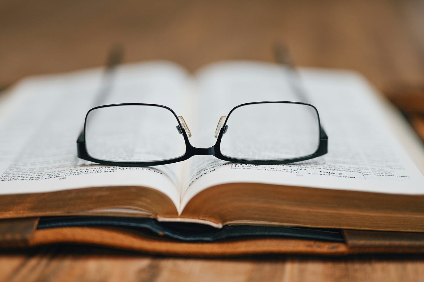 Eyeglasses on an open Bible