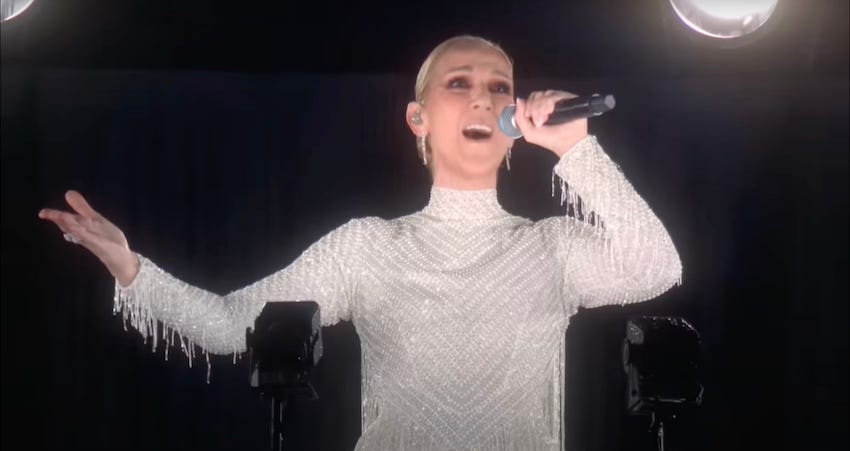 Céline Dion singing her heart out up the Eiffel Tower in the rain in a lovely white frock