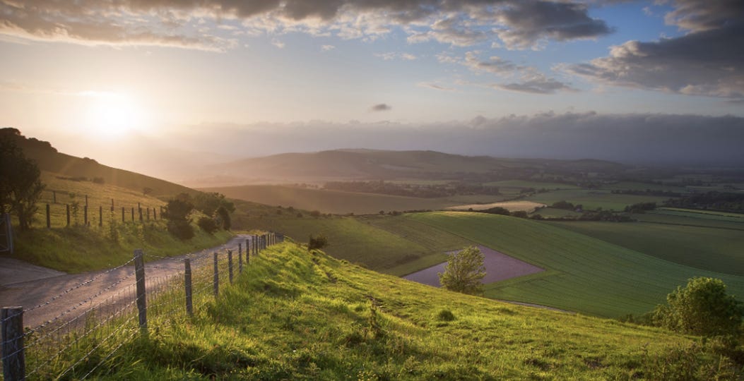 A road leading to a valley AI-generated content may be incorrect.