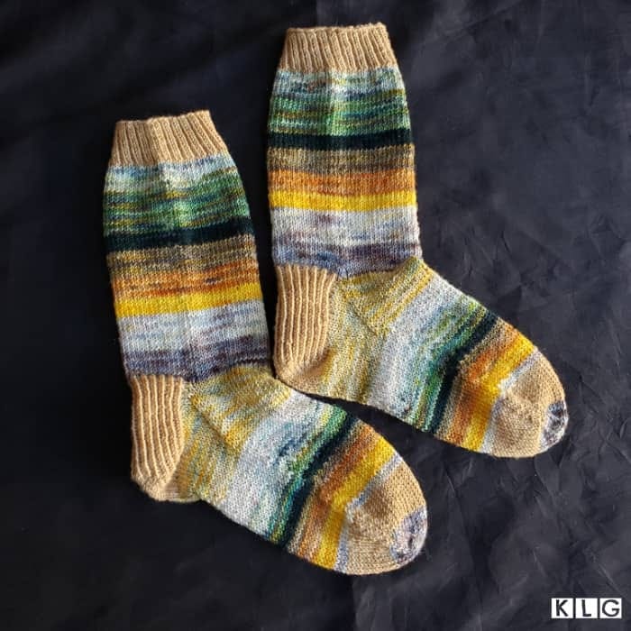 My completed free form striped Koigu Yarn socks. Colors include light browns, greys, whites, blues, yellows, oranges and greens