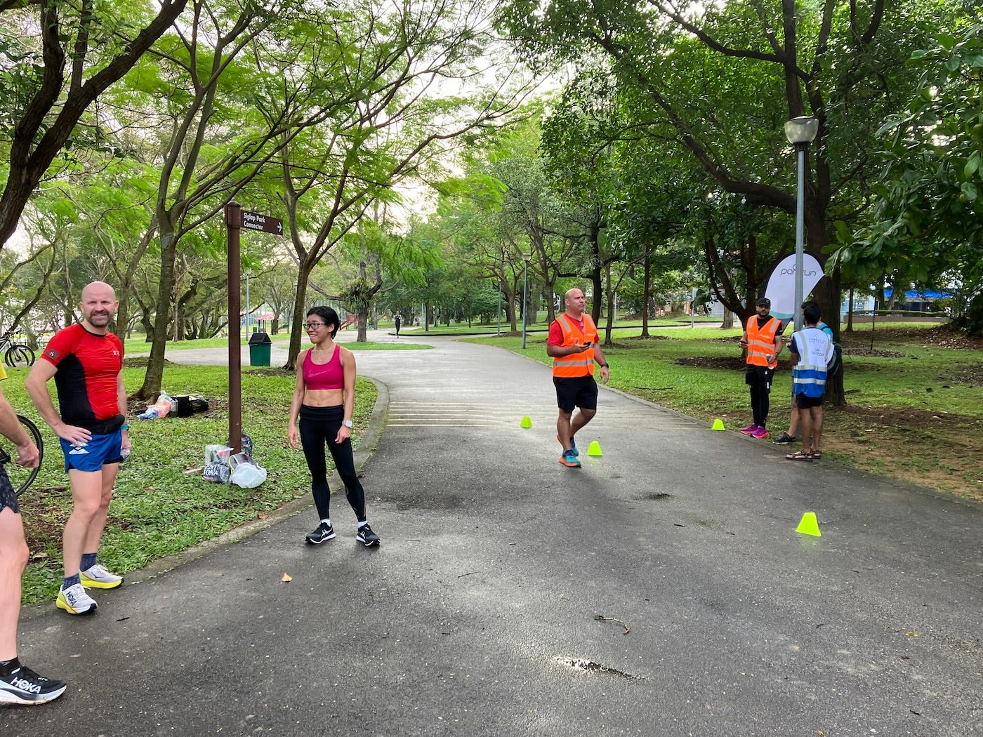 Finishers and volunteers at the finish, which is marked by low yellow cones