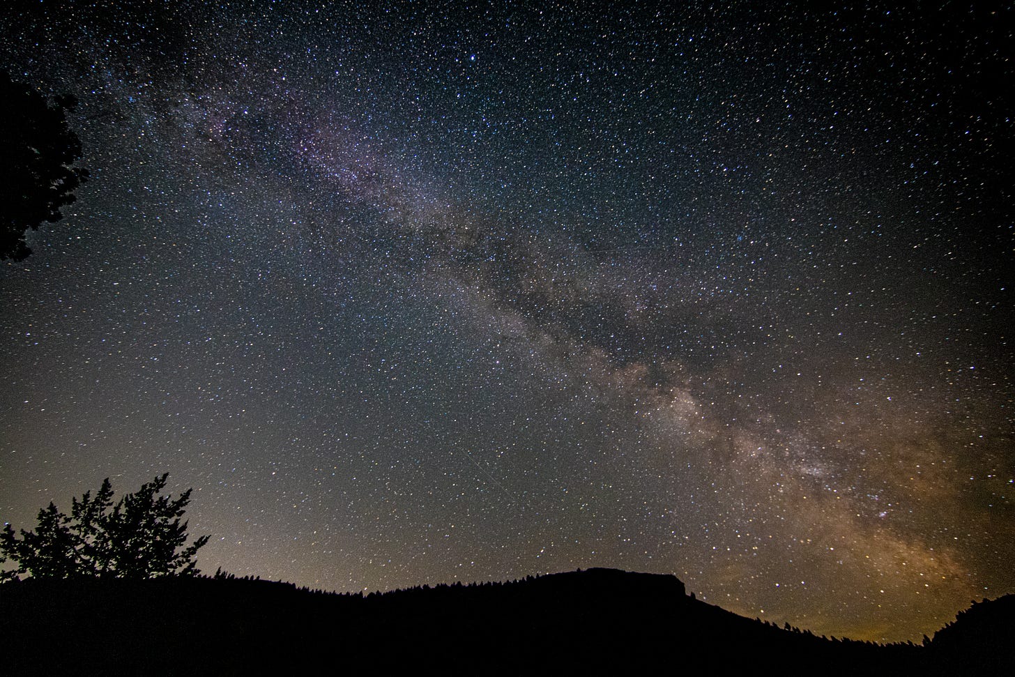 Milky Way sky with a slightly mountainous foreground
