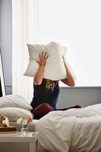 Woman Sitting In Bed With Pillow Over Face Stock Photo - Download Image Now  - Adult, Adults Only, Bed - Furniture - iStock