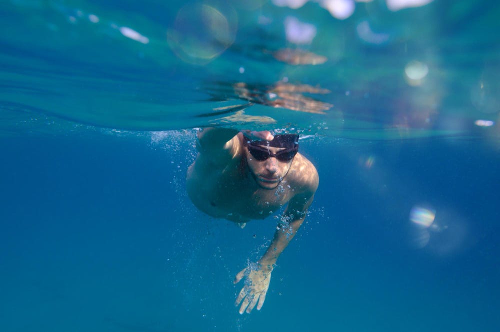 Sporty young man swimming in the sea.