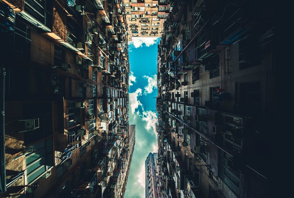 Looking at the sky from the ground level of skyscrapers.