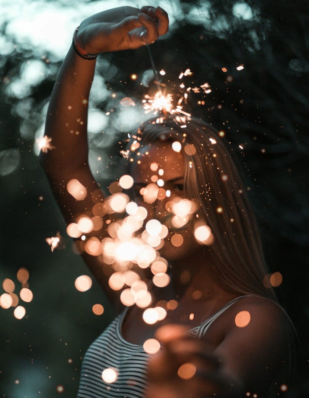 woman holding sparklers bokeh photography woman holding sparklers bokeh photography