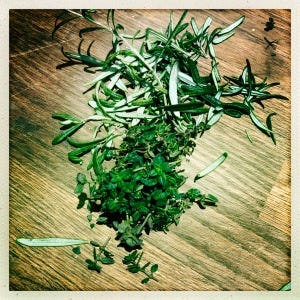 Rosemary and thyme on a chopping board