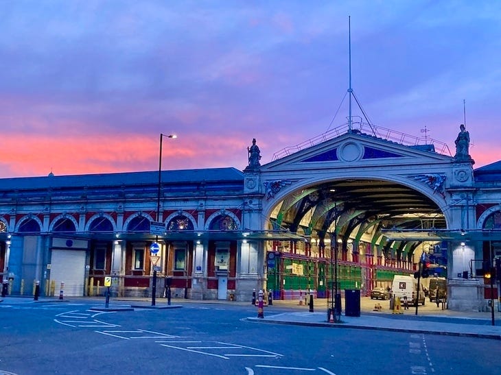 Smithfield Market with a pink sunset behind it