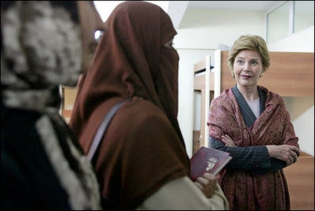 Former First Lady Laura Bush talks with female students in the National Women’s Dormitory on the campus of Kabul University in 2005, in Kabul, Afghanistan. The women’s dormitory was built to provide a safe place for young women to live while pursuing studies away from their families. (Photo: White House archives)