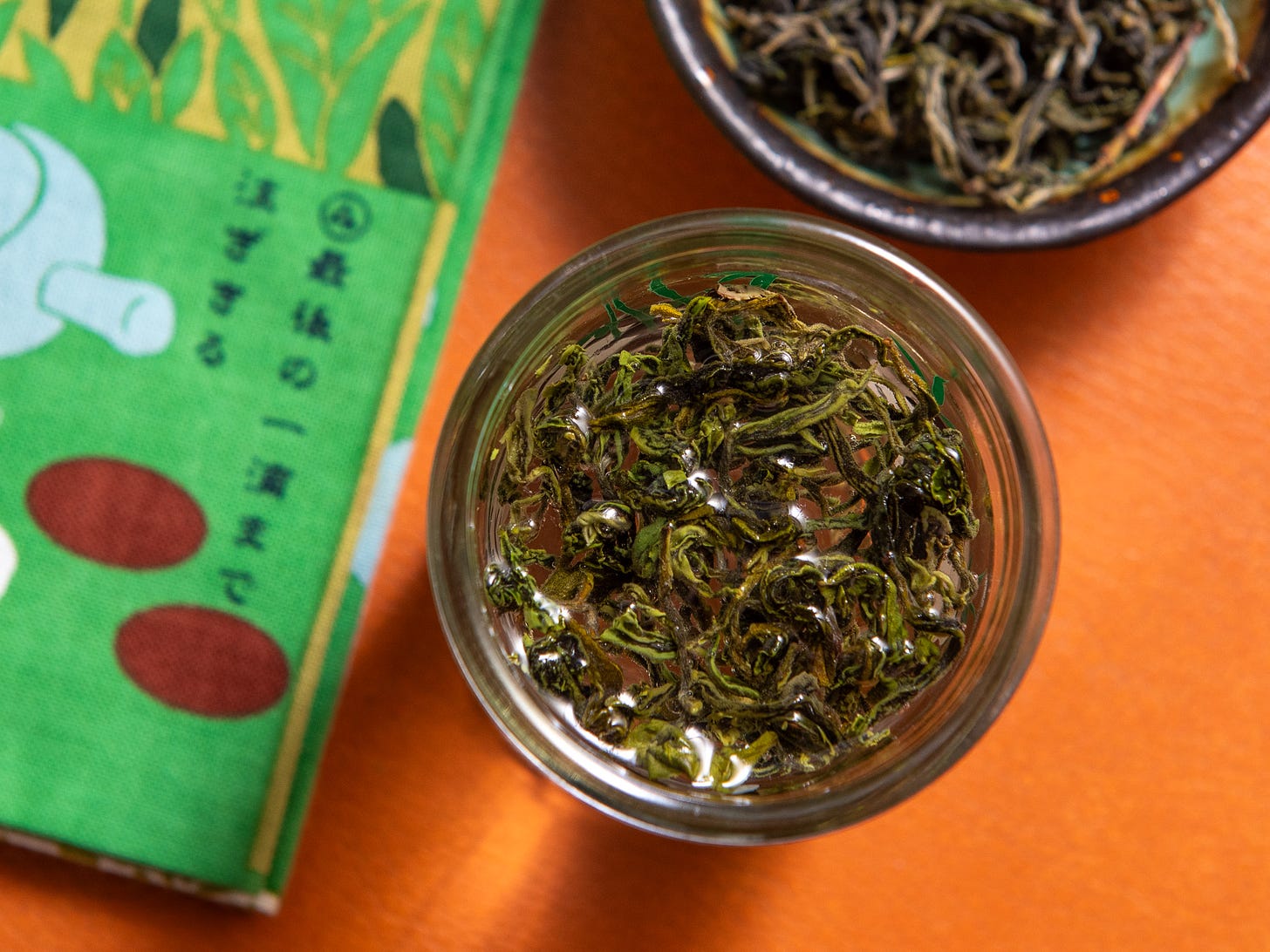 ID: Brewing bi luo chun green tea in a tall glass