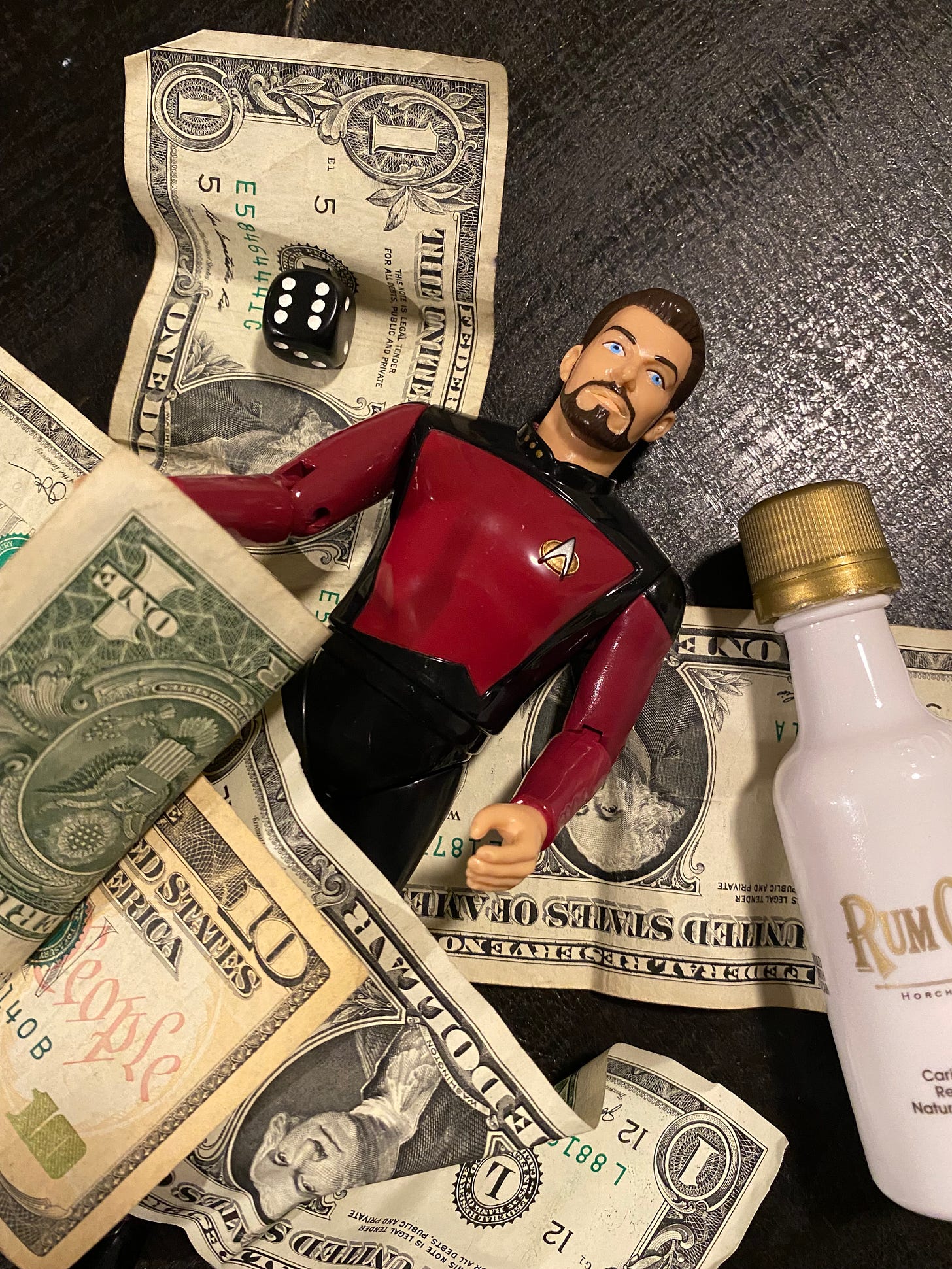 Little Riker with money, booze, and dice