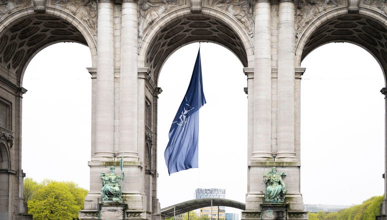 Monuments throughout the Brussels are marking NATO’s anniversary. In Parc du Cinquantenaire, the NATO flag is flying under the Memorial Arch