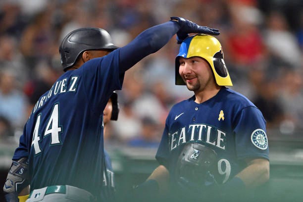 Jarret DeHart of the Seattle Mariners celebrates with Cal Raleigh after Raleigh hit a three-run home run during the sixth inning against the...