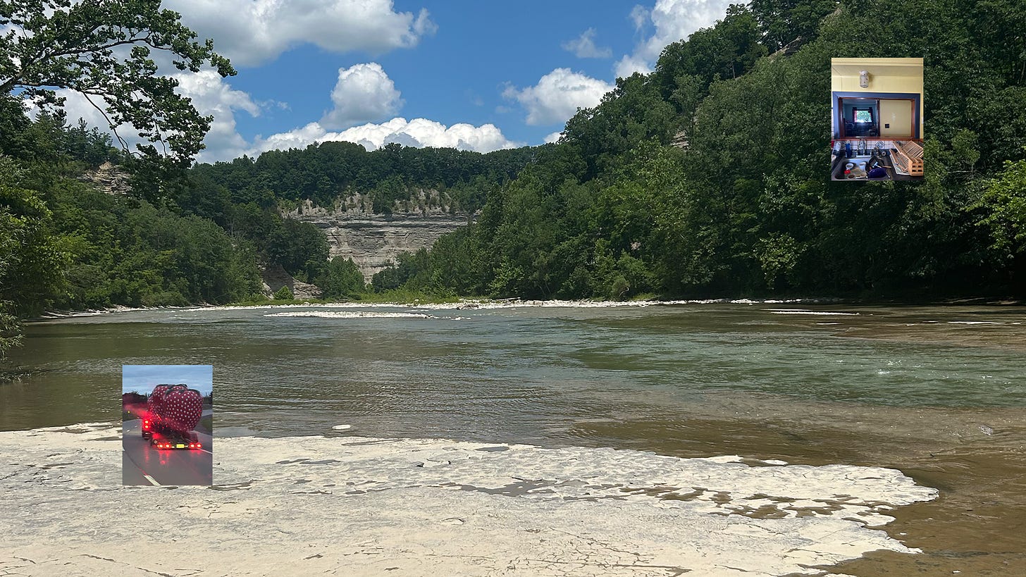 A large image of a blue waters of cattaraugus creek flowing through a stone gorge called soar valley on a sunny day. In the bottom left corner is a small image of two large red metal strawberries driving down a highway. In the upper right hand corner is an image repeating squares, from a kitchen sink and then window above it to a wooden table with a window above it, overlooking a covered porch, opening to a residential city street. 