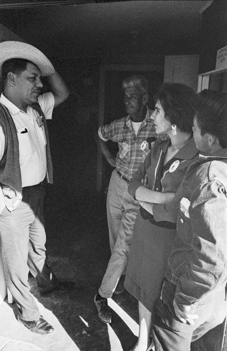 (L-R) Pancho Medrano (with a hat), Rafael Treviño, Daría Vera, and an unidentified man stand in front of the FWOC headquarters in Río Grande City, Texas, 1966. Photo by Emmon Clarke. © Tom and Ethel Bradley Center.